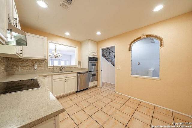 3922 Barrington Unit 0, San Antonio, TX 78217 - kitchen with a sink, appliances with stainless steel finishes, light countertops, white cabinetry, and recessed lighting