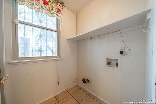 3922 Barrington Unit 0, San Antonio, TX 78217 - laundry area featuring hookup for a washing machine, light tile patterned flooring, and a textured ceiling