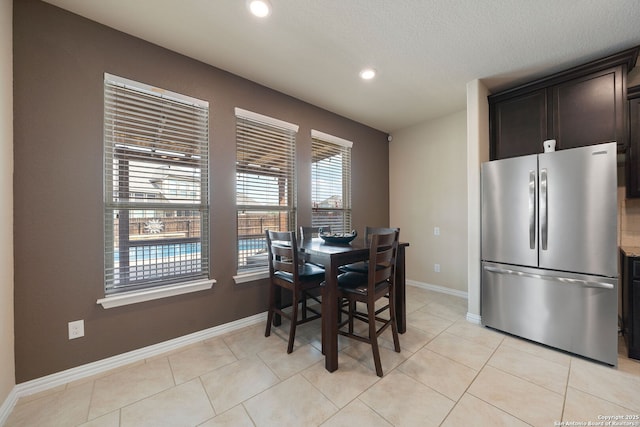 8726 Hideout, San Antonio, TX 78254 - dining space with recessed lighting, baseboards, and light tile patterned floors