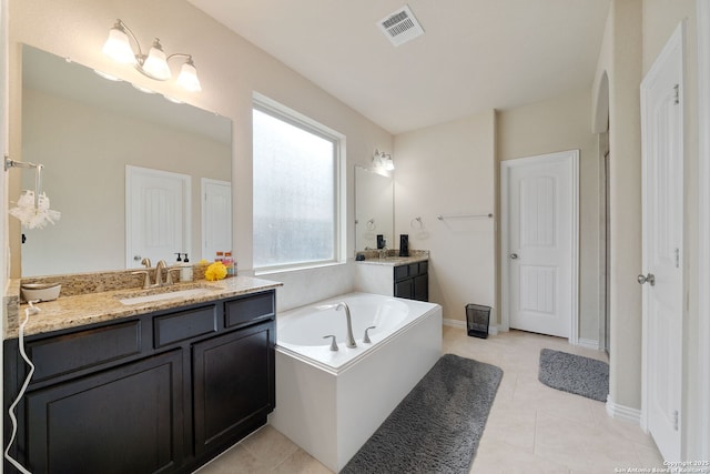 8726 Hideout, San Antonio, TX 78254 - full bathroom with two vanities, a bath, and tile patterned floors