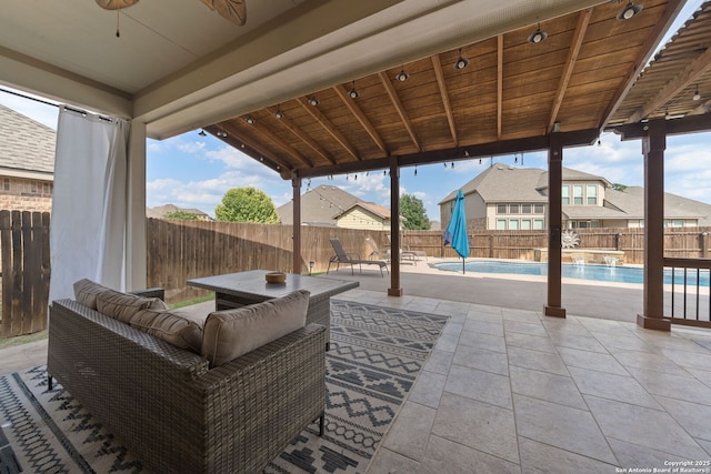8726 Hideout, San Antonio, TX 78254 - fenced backyard with ceiling fan, a patio area, and an outdoor hangout area