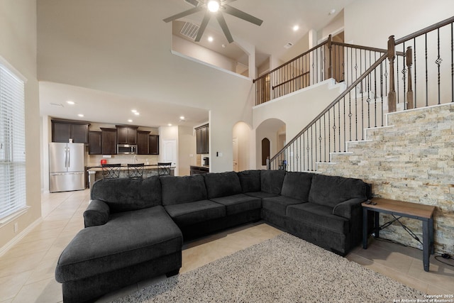8726 Hideout, San Antonio, TX 78254 - living room featuring a towering ceiling, arched walkways, light tile patterned floors, a ceiling fan, and recessed lighting