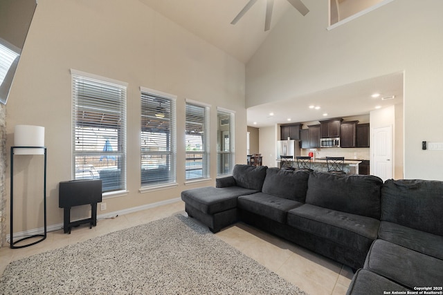 8726 Hideout, San Antonio, TX 78254 - living area featuring light tile patterned floors, ceiling fan, healthy amount of natural light, and high vaulted ceiling