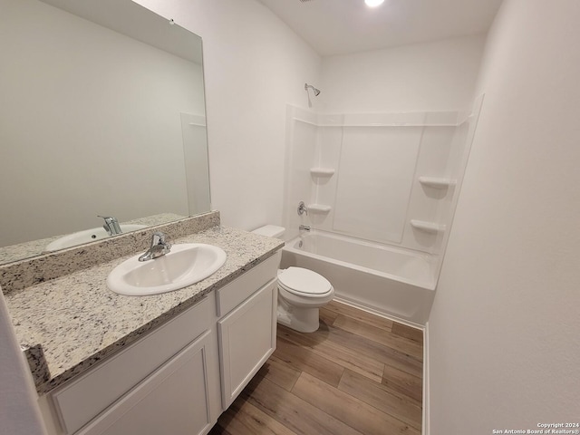 15107 Telfaire Mdw, Von Ormy, TX 78073 - bathroom with toilet, vanity, washtub / shower combination, and wood finished floors