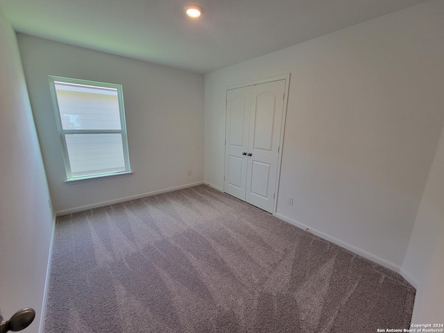 15107 Telfaire Mdw, Von Ormy, TX 78073 - unfurnished bedroom featuring carpet floors, baseboards, a closet, and recessed lighting