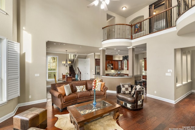 7414 Hovingham, San Antonio, TX 78257 - living area featuring wood finished floors, a ceiling fan, a high ceiling, stairway, and a chandelier