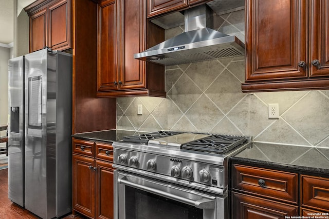 7414 Hovingham, San Antonio, TX 78257 - kitchen featuring stainless steel appliances, wall chimney exhaust hood, backsplash, dark stone countertops, and dark brown cabinets