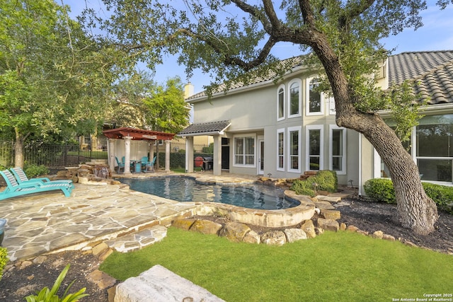 7414 Hovingham, San Antonio, TX 78257 - rear view of house with an outdoor pool, a tile roof, stucco siding, a patio, and a hot tub