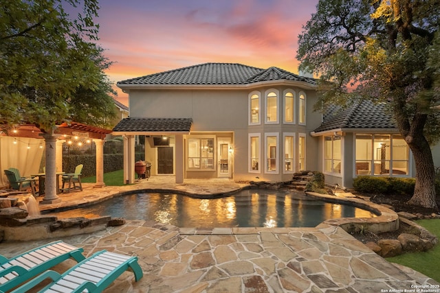 7414 Hovingham, San Antonio, TX 78257 - back of house featuring a patio, a tile roof, an outdoor pool, and stucco siding