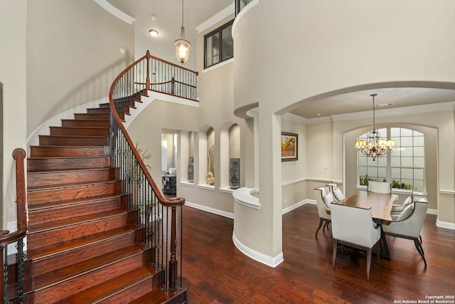 7414 Hovingham, San Antonio, TX 78257 - dining room with arched walkways, wood finished floors, stairs, baseboards, and ornamental molding