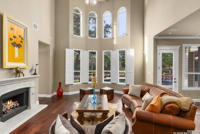 7414 Hovingham, San Antonio, TX 78257 - living area featuring a high ceiling, a fireplace, dark wood-type flooring, baseboards, and a ceiling fan