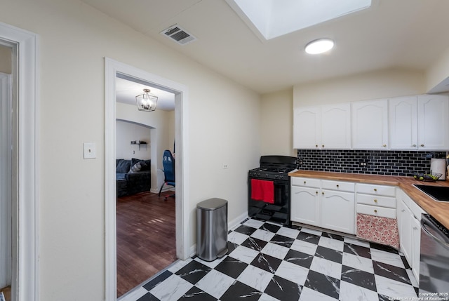 1019 Chicago Blvd, San Antonio, TX 78210 - kitchen with butcher block counters, black gas range oven, dishwasher, light flooring, and white cabinetry