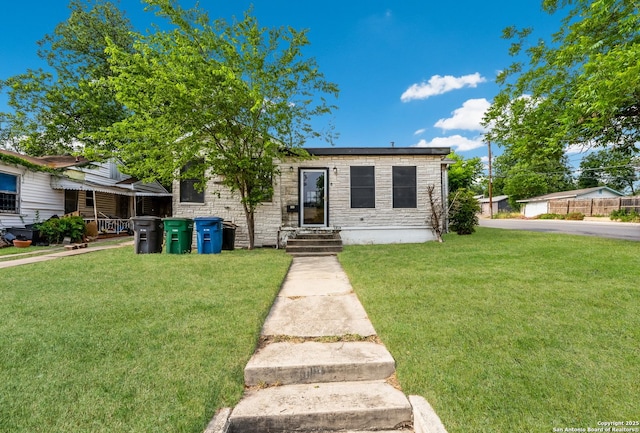 1019 Chicago Blvd, San Antonio, TX 78210 - view of front facade featuring a front yard, stone siding, and entry steps