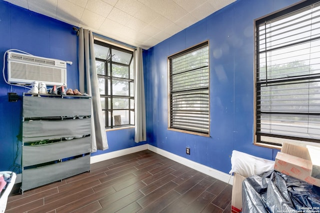 1019 Chicago Blvd, San Antonio, TX 78210 - interior space featuring baseboards, an AC wall unit, and dark wood finished floors