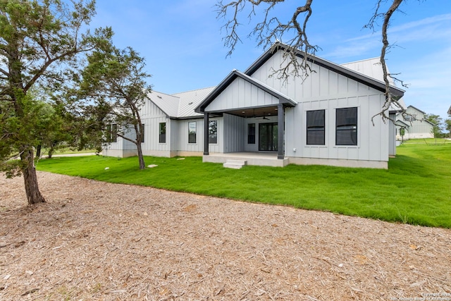 33 Peace Pipe, Wimberley, TX 78676 - rear view of house with board and batten siding, a ceiling fan, and a lawn