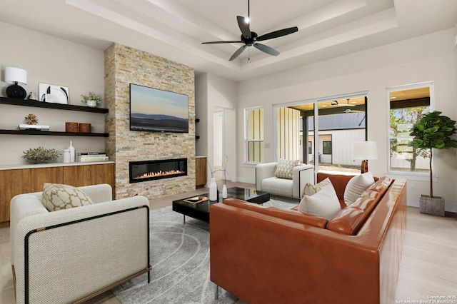 33 Peace Pipe, Wimberley, TX 78676 - living room with a tray ceiling, ceiling fan, and a stone fireplace