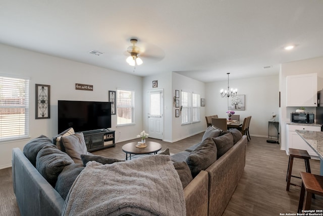 4015 Evaporite Trl, San Antonio, TX 78253 - living area featuring a chandelier, baseboards, a ceiling fan, and dark wood-type flooring