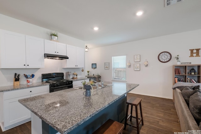 4015 Evaporite Trl, San Antonio, TX 78253 - kitchen featuring gas stove, a kitchen bar, under cabinet range hood, light stone counters, and recessed lighting