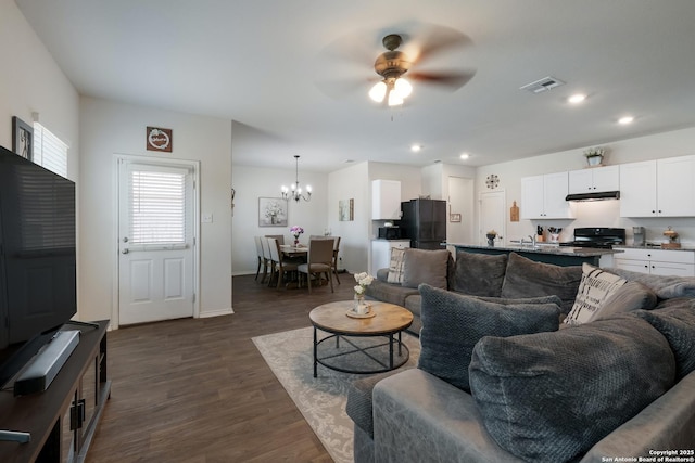 4015 Evaporite Trl, San Antonio, TX 78253 - living room featuring ceiling fan, dark wood-style floors, a chandelier, baseboards, and recessed lighting