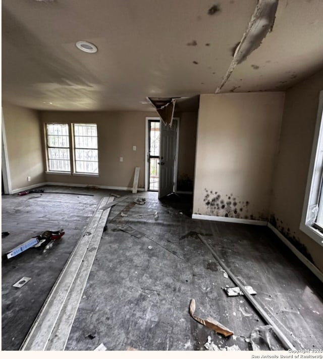 726 Price, San Antonio, TX 78211 - unfurnished living room featuring baseboards