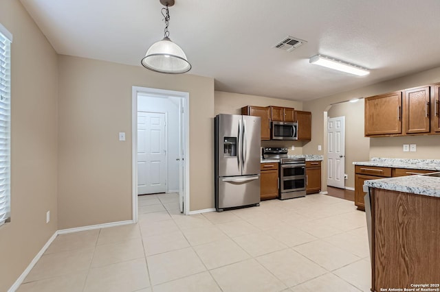 3803 Ponderosa Bnd, San Antonio, TX 78261 - kitchen featuring appliances with stainless steel finishes, arched walkways, brown cabinetry, and decorative light fixtures