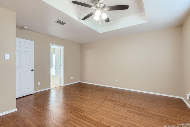 3803 Ponderosa Bnd, San Antonio, TX 78261 - empty room with a raised ceiling, wood finished floors, a ceiling fan, crown molding, and baseboards