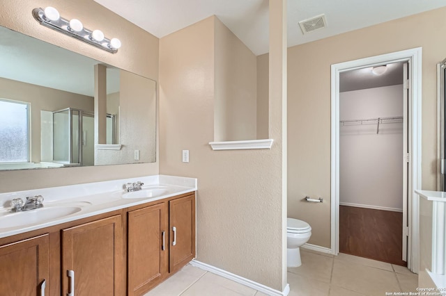 3803 Ponderosa Bnd, San Antonio, TX 78261 - bathroom featuring tile patterned flooring, double vanity, toilet, and a shower with shower door