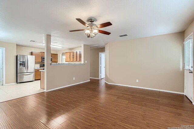 3803 Ponderosa Bnd, San Antonio, TX 78261 - unfurnished living room with a ceiling fan, light wood finished floors, and baseboards