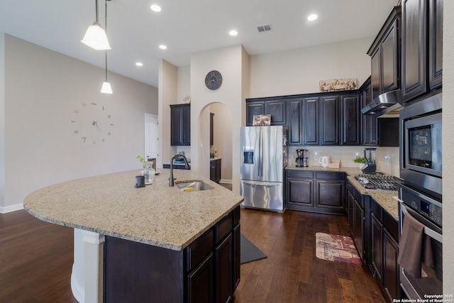 364 Stone Trl, Castroville, TX 78009 - kitchen with appliances with stainless steel finishes, a sink, dark wood finished floors, light stone counters, and recessed lighting