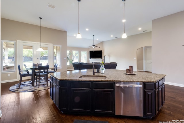 364 Stone Trl, Castroville, TX 78009 - kitchen featuring stainless steel dishwasher, a sink, light stone counters, dark wood-type flooring, and open floor plan
