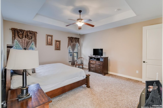 364 Stone Trl, Castroville, TX 78009 - bedroom featuring a raised ceiling, baseboards, light carpet, and ceiling fan