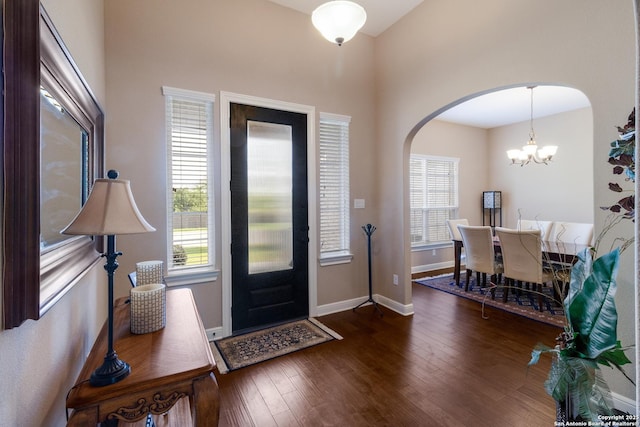 364 Stone Trl, Castroville, TX 78009 - entrance foyer featuring arched walkways, healthy amount of natural light, wood finished floors, a high ceiling, and baseboards