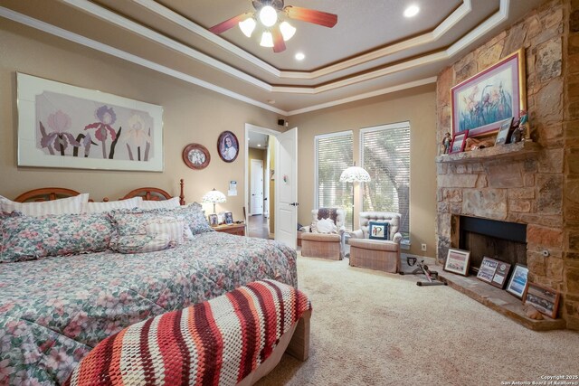 10402 Oak Forest Way, New Braunfels, TX 78132 - carpeted bedroom featuring ornamental molding, a tray ceiling, a stone fireplace, and recessed lighting