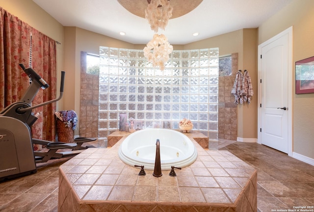 10402 Oak Forest Way, New Braunfels, TX 78132 - bathroom with a tub with jets, a chandelier, baseboards, and stone finish floors