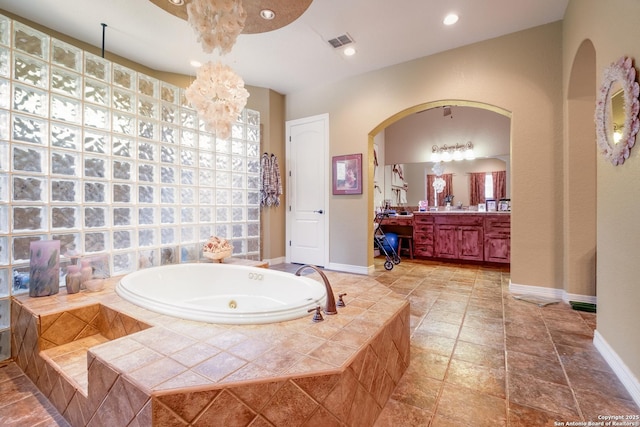 10402 Oak Forest Way, New Braunfels, TX 78132 - bathroom with vanity, a tub with jets, baseboards, a chandelier, and recessed lighting
