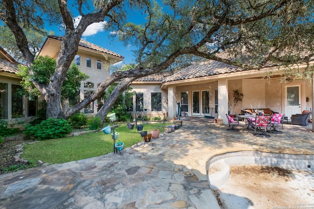 10402 Oak Forest Way, New Braunfels, TX 78132 - back of house with stucco siding, french doors, a tiled roof, a patio, and a yard