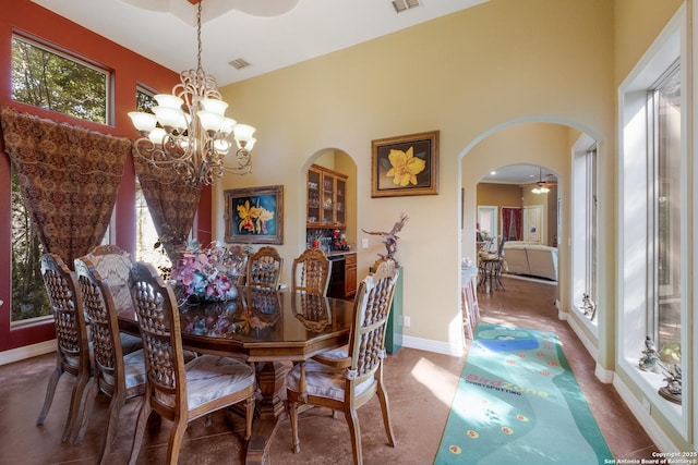 10402 Oak Forest Way, New Braunfels, TX 78132 - dining room featuring a chandelier, arched walkways, and baseboards
