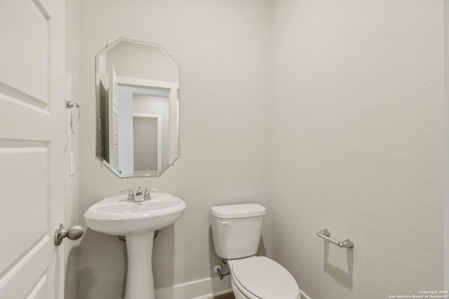 29414 Angelfish Blvd, Boerne, TX 78006 - half bath featuring toilet, baseboards, and a sink