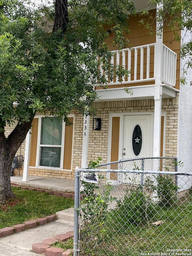 1336 Churing, San Antonio, TX 78245 - entrance to property with a balcony, stucco siding, and brick siding