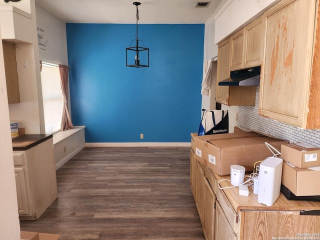 2960 Ash Fld, San Antonio, TX 78245 - kitchen featuring under cabinet range hood, dark wood-style floors, hanging light fixtures, a chandelier, and baseboards