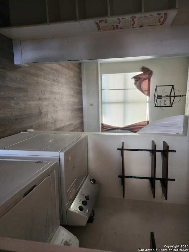2960 Ash Fld, San Antonio, TX 78245 - laundry area with wood walls and washer and dryer