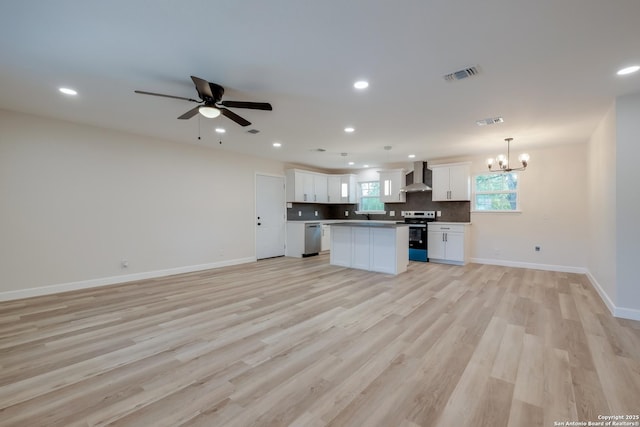 7811 Stagecoach, San Antonio, TX 78227 - kitchen with wall chimney range hood, open floor plan, electric range, stainless steel dishwasher, and a chandelier