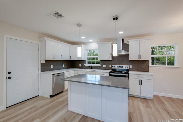 7811 Stagecoach, San Antonio, TX 78227 - kitchen with wall chimney range hood, appliances with stainless steel finishes, a sink, light wood-style flooring, and recessed lighting