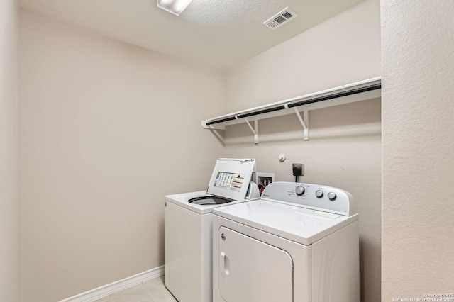 4811 Tee Box Ct, San Antonio, TX 78261 - laundry area with washer and dryer, light tile patterned floors, and baseboards