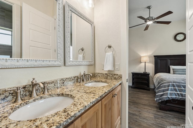 1015 Broken Spoke, Canyon Lake, TX 78133 - ensuite bathroom featuring wood finished floors, a ceiling fan, double vanity, and baseboards