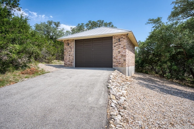 1015 Broken Spoke, Canyon Lake, TX 78133 - detached garage featuring asphalt driveway