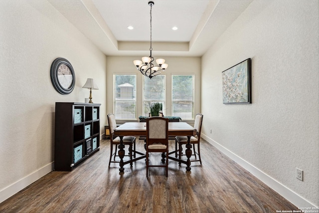 1015 Broken Spoke, Canyon Lake, TX 78133 - dining space with a chandelier, dark wood-style flooring, baseboards, a textured wall, and a raised ceiling