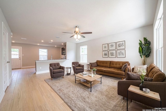 324 Mar Hl, Seguin, TX 78155 - living area with light wood finished floors, healthy amount of natural light, recessed lighting, a ceiling fan, and baseboards