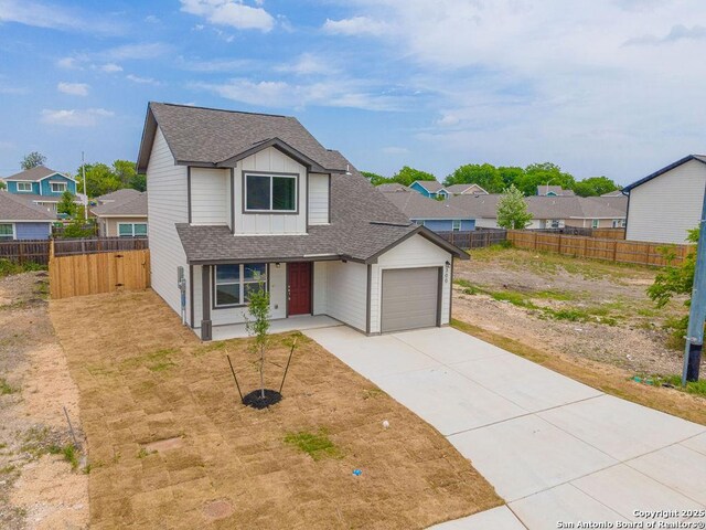 300 W Martindale, Seguin, TX 78155 - traditional-style house featuring a shingled roof, a garage, concrete driveway, board and batten siding, and a residential view