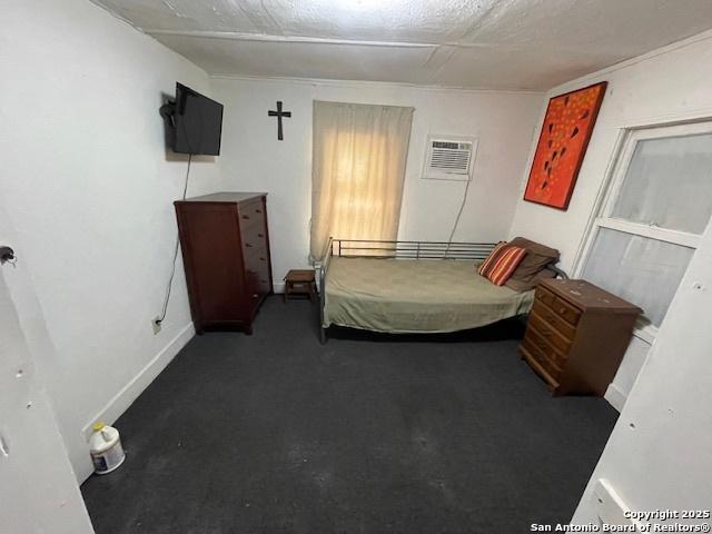 261 San Gabriel, San Antonio, TX 78237 - carpeted bedroom featuring a wall mounted AC